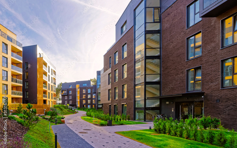 Apartment in residential building exterior. Housing structure at blue modern house of Europe. Rental home in city district on summer. Wall and glass high architecture for business property investment.