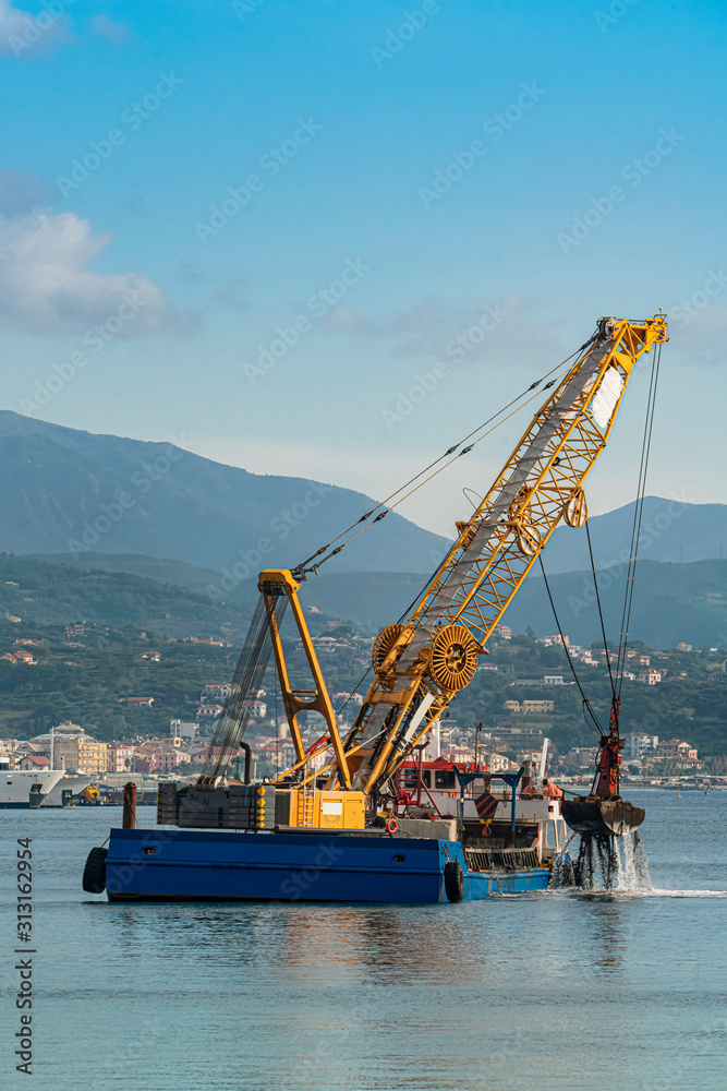 Hopper dredger working in old port of Savona, Italy