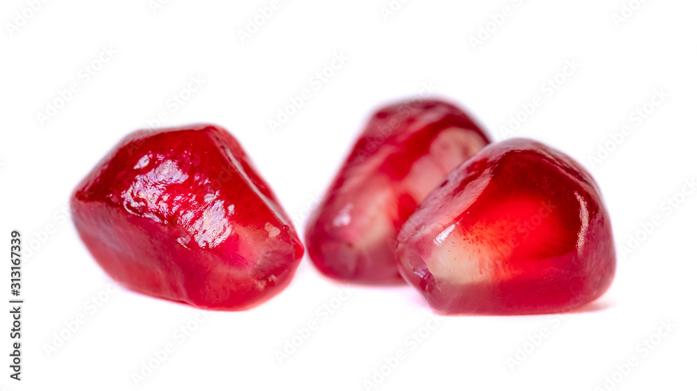 Fresh pomegranate seeds isolated on white background. Close up.