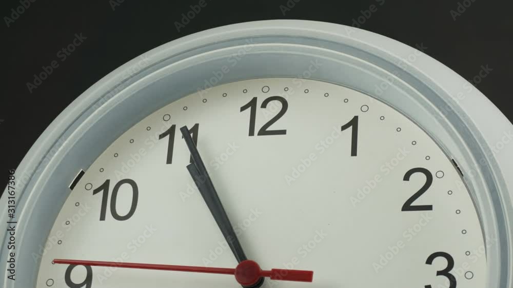 Ten o'clock White wall clock face beginning of time 10.45 am, Time lapse 30 minutes moving fast. Ten o'clock White wall clock face beginning of time 10.45 am, Time lapse 30 minutes moving fast.