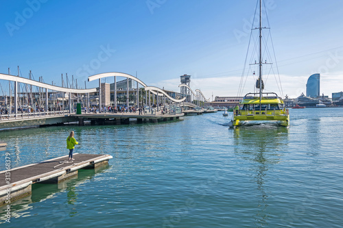 Port Vell with catamaran, Maremagnum, tower Torre Sant Sebastia and W Barcelona photo