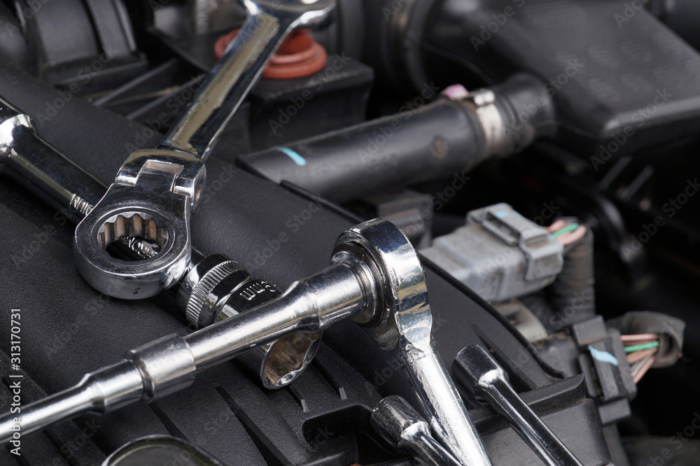 Car repair workshop. Wrenches for repair lying in the engine compartment. Car repair workshop. Wrenches for repair lying in the engine compartment.