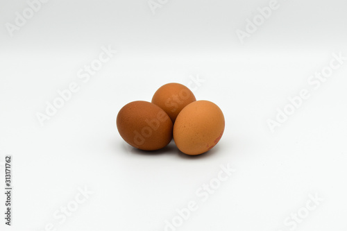 Three Organic chicken eggs isolated on white background