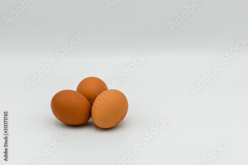 Three Organic chicken eggs isolated on white background