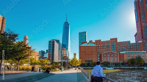 Business people and children in a metropolitan area with playgrounds and buildings in the city. Fast paced lifestyle in Manhattan, New York City with Freedom Tower building.