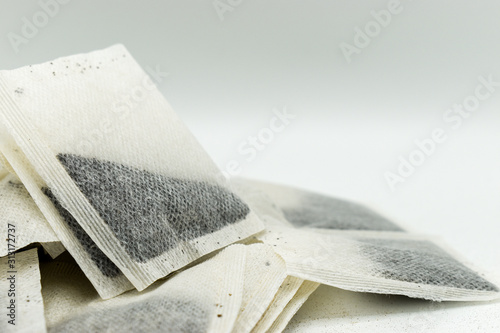 Heap of tea bags isolated on white background photo