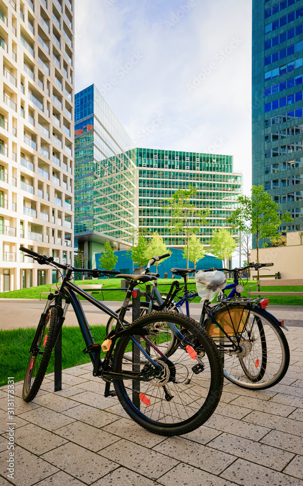 Bicycles parked at Modern apartment residential and flat building exterior in Vienna, Austria. New luxury house and home complex. City Real estate property and condo architecture. Bikes at Condominium
