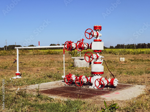 Well for oil and gas production. Oil well wellhead equipment. Oil production photo