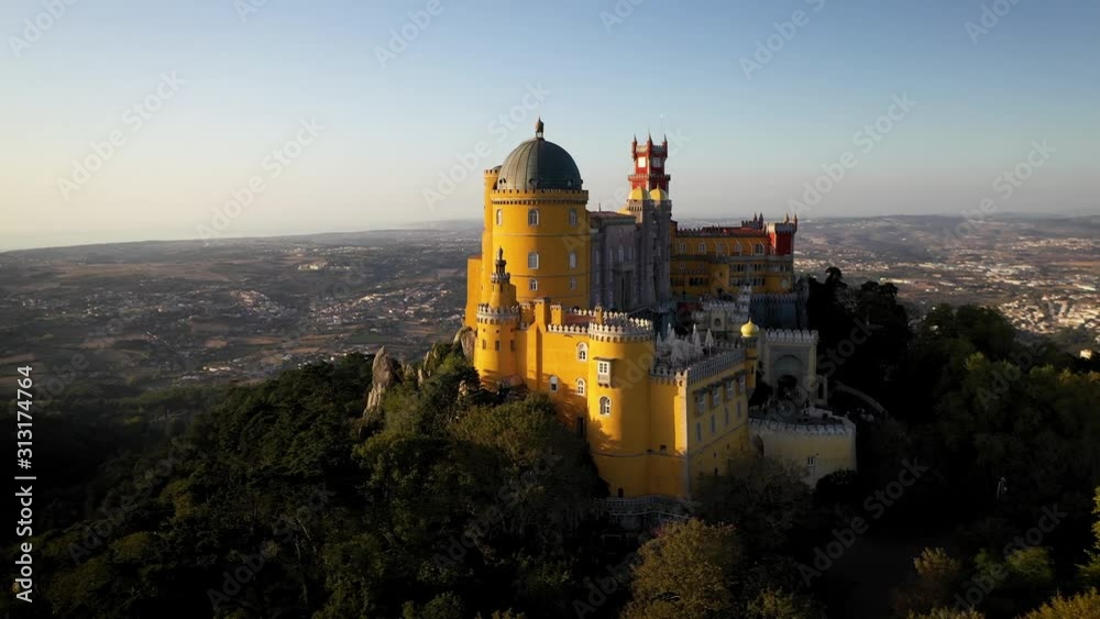 Low aerial orbit of Pena Palace castle, stood on the mountain top above Sintra town in Portugal. Low aerial orbit of Pena Palace castle, stood on the mountain top above Sintra town in Portugal.