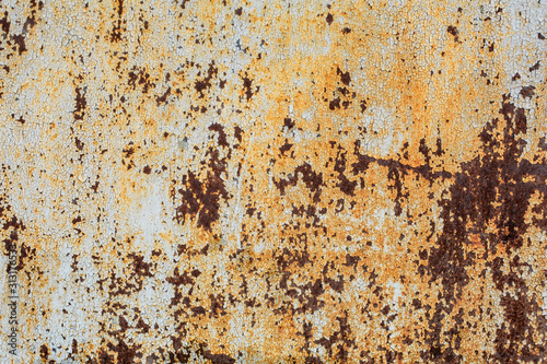 texture of an old rusty sheet of metal painted with white paint burnt out in the sun