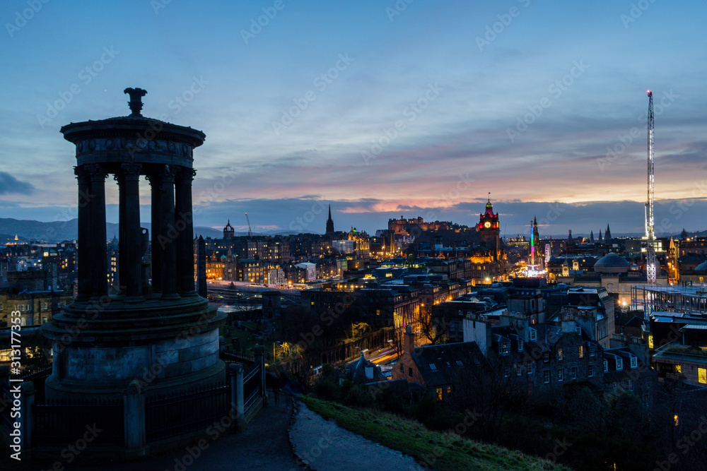 Sunset from Calton Hill in Edinburgh with panoramic view of the castle and Christmas market