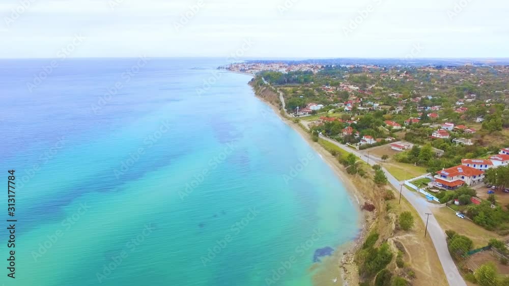 Panoramic view of coast on a hill with houses by the blue sea Panoramic view of coast on a hill with houses by the blue sea