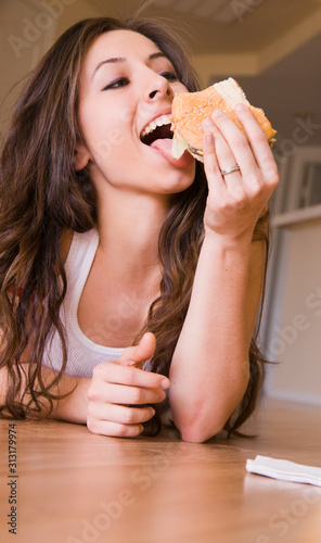 Pretty girl eats a burger