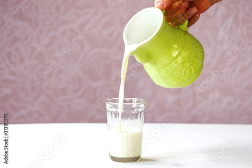 Εκτύπωση καμβά Fresh, homemade milk in a cup made of glass on a white table