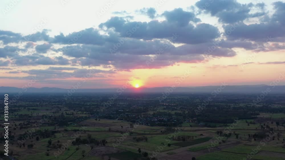 Beautiful sunset sky over a green meadows with mixed forest; agricultural fields with last sunlight shining through the clouds in summer evening; footage b roll scene 4k shot. Beautiful sunset sky over a green meadows with mixed forest; agricultural fields with last sunlight shining through the clouds in summer evening; footage b roll scene 4k shot.