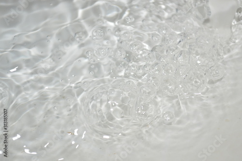 The surface of the water in a white container