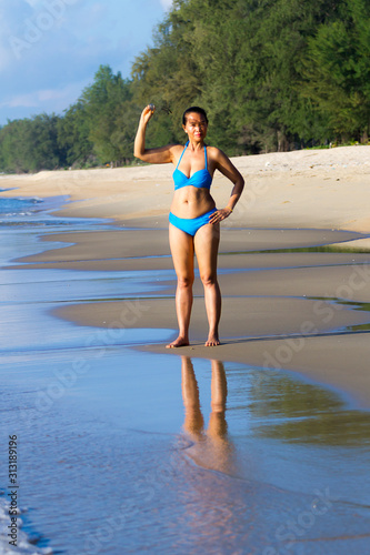 Woman show shape and bikini blue at the beach
