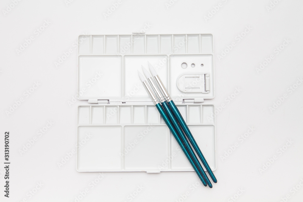 Pallet with painting brushes isolated on white Pallet with painting brushes isolated on white