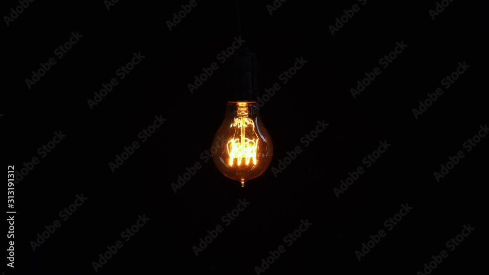 Light bulb turns on and off in dark background