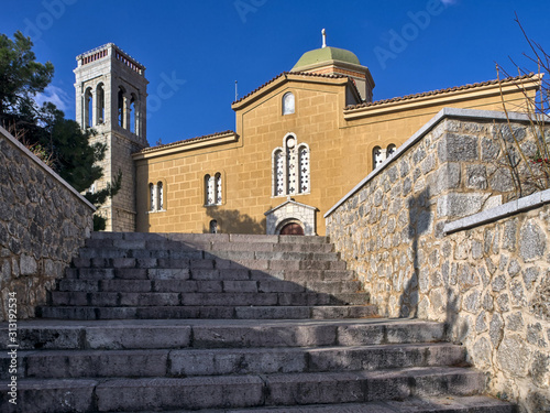 Wallpaper Mural Arahova, Parnassos, Greece, stone steps lead to Agios Georgios (Saint George) church under deep blue sky. Torontodigital.ca