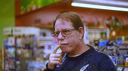 Man plays funny character by making goofy faces and gestures in store photo
