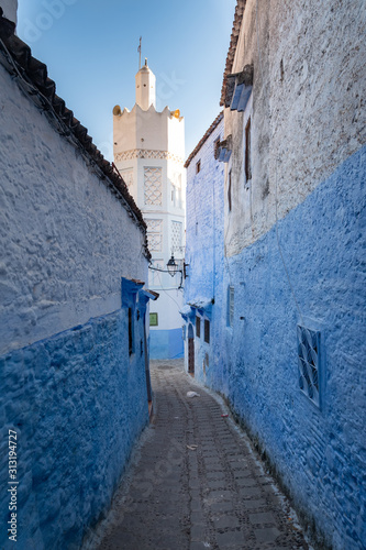 Narrow street with a Minaret in Chefchaouen, Morocco © Alvaro Lovazzano