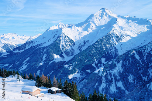 Panorama of ski resort town Mayrhofen and chalet houses in Tyrol in Zillertal valley in Austria in winter Alps. Landscape and cityscape with Alpine mountains with white snow. View from Penken park