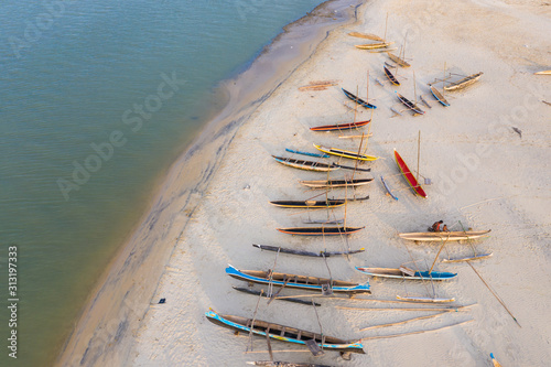 Colourful Pirogues at the beach in Morondava, Madagascar photo