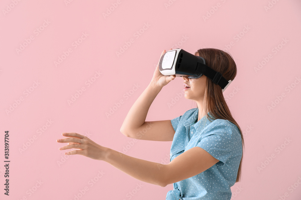 Young woman with virtual reality glasses on color background Young woman with virtual reality glasses on color background