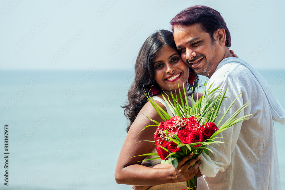 indian male making proposal with engagement ring and roses to his girlfriend at sea beach.Valentine day at Goa indian male making proposal with engagement ring and roses to his girlfriend at sea beach.Valentine day at Goa