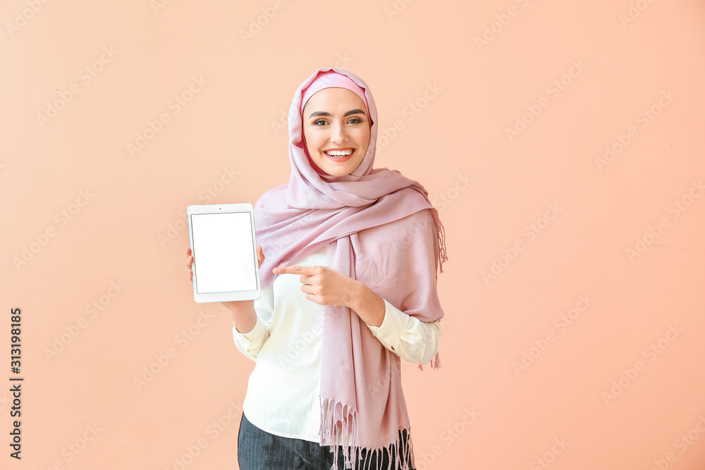 Beautiful Arab woman with tablet computer on color background Beautiful Arab woman with tablet computer on color background