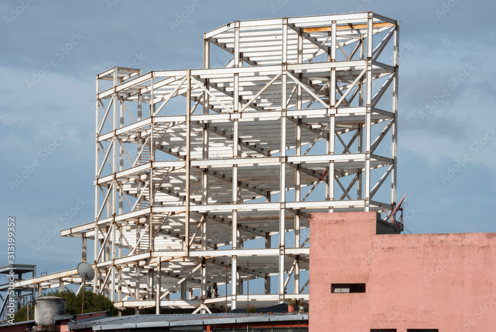 Metal structure for the construction of modern building in Guatemala City, civil engineering and urban architecture, integration of spaces in Latin American city.