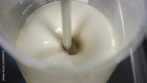 Making body and facecare production. lab technician chemist cosmetician mixing cosmetic ingredients in glass tube in laboratory conditions. Slow motion. Full hd