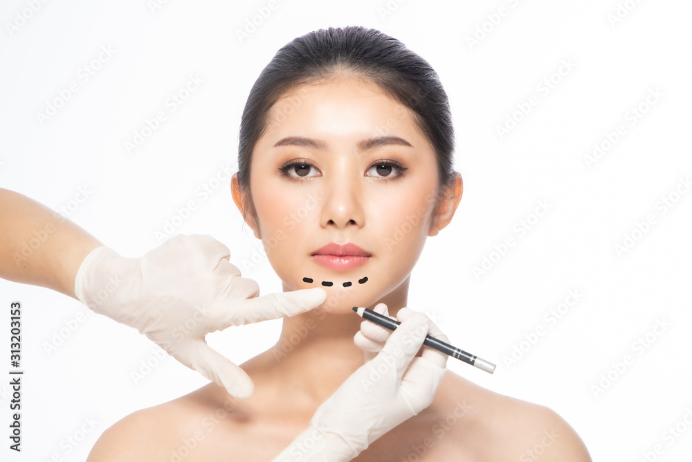 Lines on face, close up, plastic surgery concept, doctor's hand in glove making marks on patient's face..Asian beauty Woman in beauty salon. plastic surgery clinic. Lines on face, close up, plastic surgery concept, doctor's hand in glove making marks on patient's face..Asian beauty Woman in beauty salon. plastic surgery clinic.