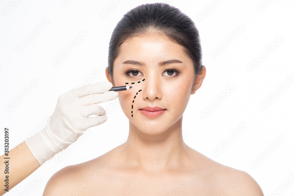 Lines on face, close up, plastic surgery concept, doctor's hand in glove making marks on patient's face..Asian beauty Woman in beauty salon. plastic surgery clinic. Lines on face, close up, plastic surgery concept, doctor's hand in glove making marks on patient's face..Asian beauty Woman in beauty salon. plastic surgery clinic.