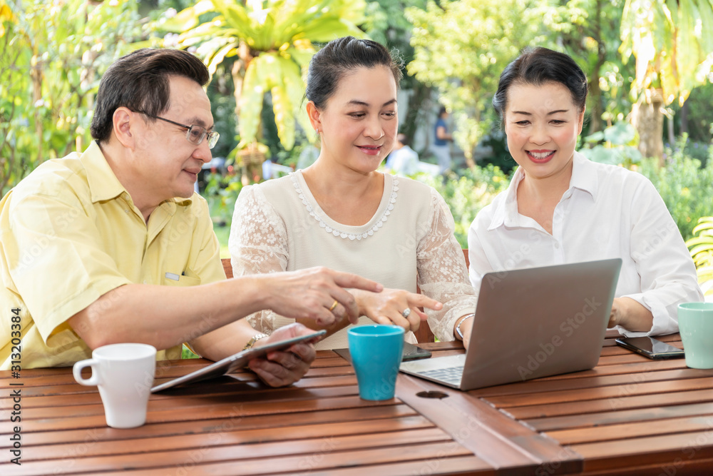 Elderly Asian friends using laptops and tablets in nursing home. Elderly Asian friends using laptops and tablets in nursing home.