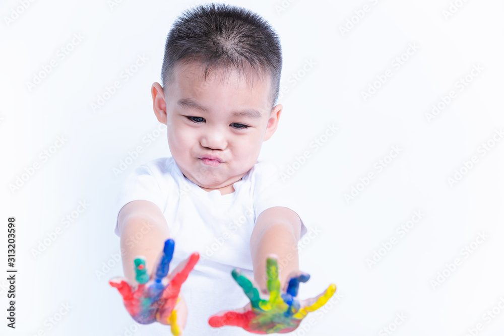 Asian portrait little baby boy show hand he have water color or finger paint on hands Asian portrait little baby boy show hand he have water color or finger paint on hands