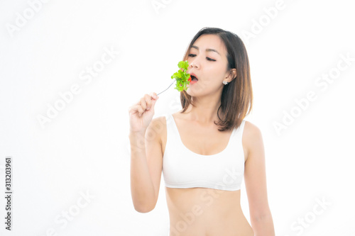Beautiful asian young woman healthy food wearing white underwear eating salads with healthy food isolated on a white background.