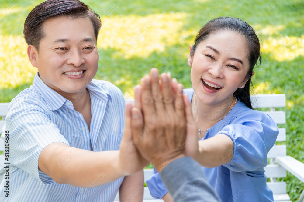 Group of senior Asian retired giving high five building successful team. Group of senior Asian retired giving high five building successful team.