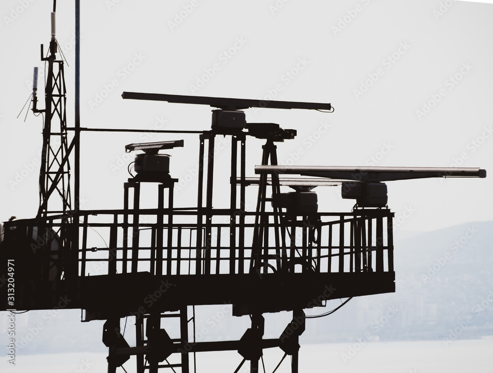 Rotating antennas of a military radio station on tower. Stock Photo ...
