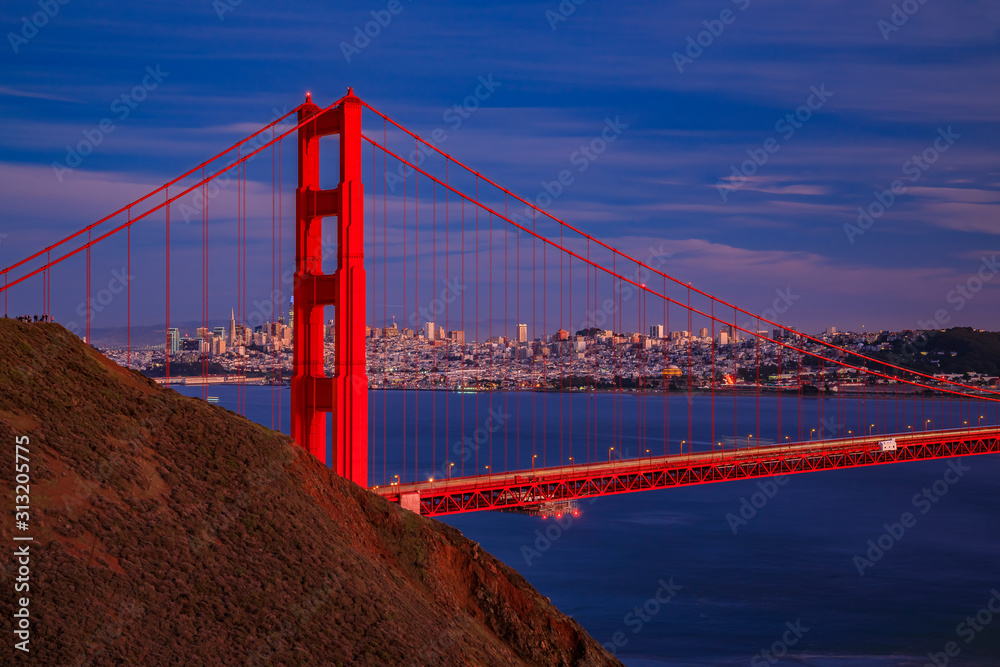View of the Golden Gate bridge with the Marin Headlands and San Francisco skyline at colorful sunset, California View of the Golden Gate bridge with the Marin Headlands and San Francisco skyline at colorful sunset, California