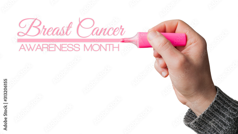 Breast cancer awareness month: man uderline a text with a pink highlighter Breast cancer awareness month: man uderline a text with a pink highlighter