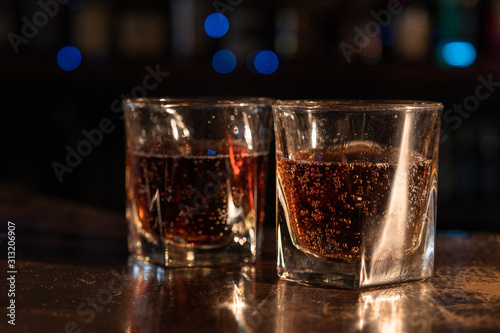 glasses of fizzy drink with black background
