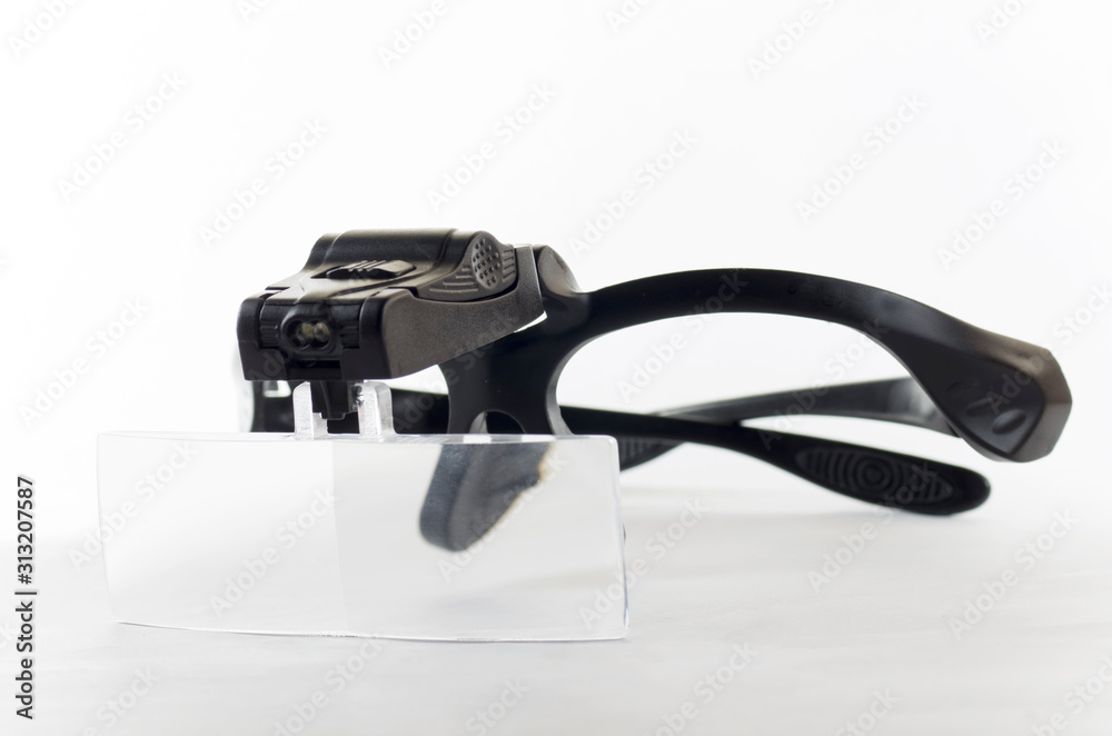 Watchmaker glasses for repair on a white background Watchmaker glasses for repair on a white background
