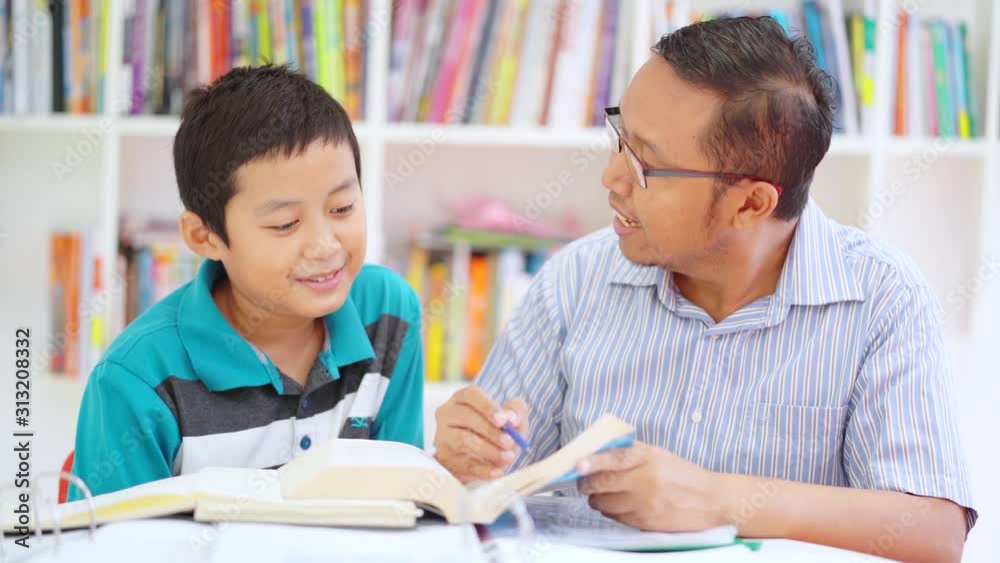 Young man helping his preteen son to study