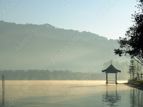 Beautiful scenery during sunrise with the water reflection of the small pavilion at the Lee Wine Ruk Thai lake, Mae Hong Son, north of Thailand.