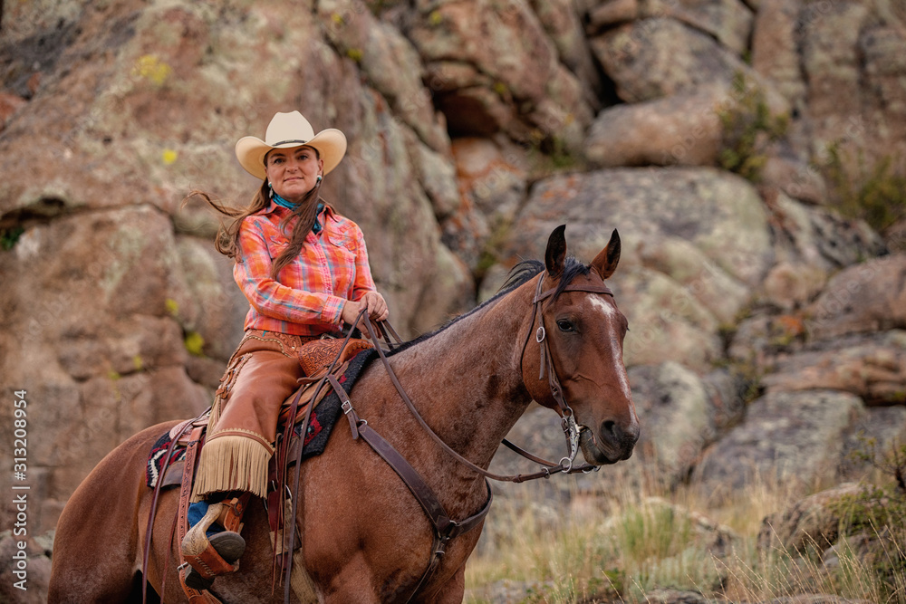 Fototapeta premium Cowgirl Riding on Rocks