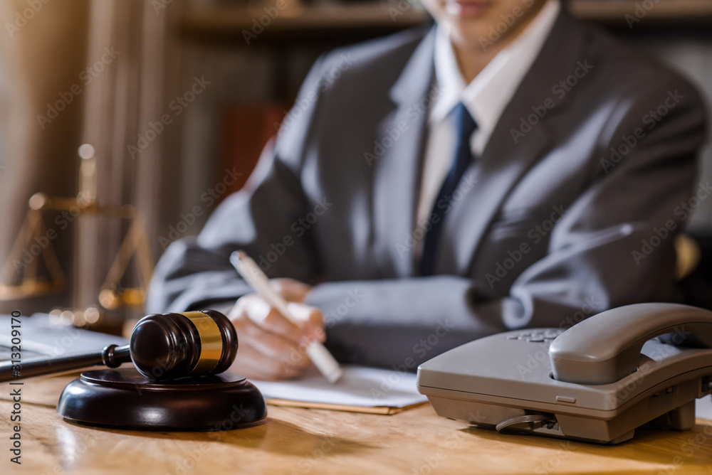 lawyer or judge work in the office with gavel and balance in the moral. lawyer or judge work in the office with gavel and balance in the moral.