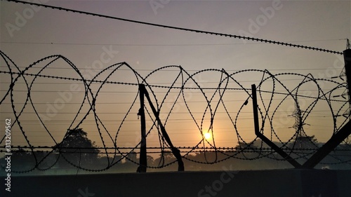 Morning Sunrise picture nicely captured behind the fencing