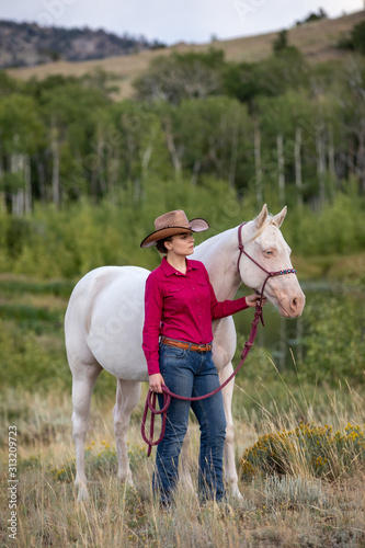 cowgirl with white horse © Terri Cage 